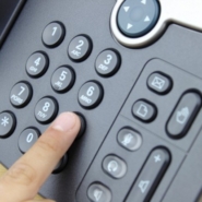 Professional handling a business phone call during the business number porting process.