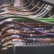 PLC wires and network connectivity equipment illustrating the difference between broadband and leased line for businesses.