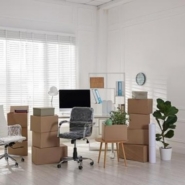 Office relocation setup with cardboard boxes, desks, and equipment during an Office Telephone System move.